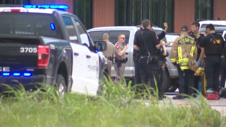 In this image taken from video provided by KVUE, emergency cervices work on a site of a shooting in Austin, Texas, Sunday, May 17, 2026. (KVUE via AP)